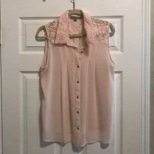 Blush pink sleeveless blouse.